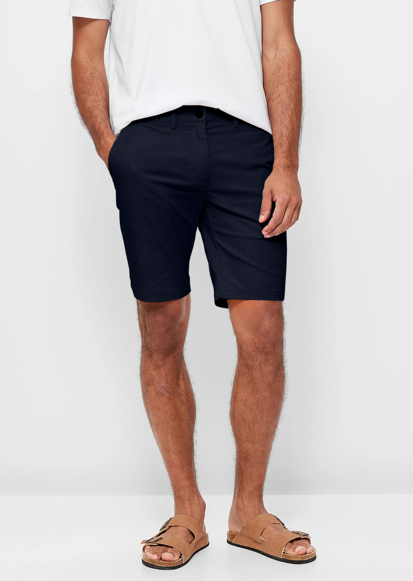Mens Navy chinos shorts with front slanted pockets, jetted back pockets. zip fly fastening and brown horne buttons on the waistband and back pockets, the fit is a slim fit, this is worn with a white tee and white t-shirt