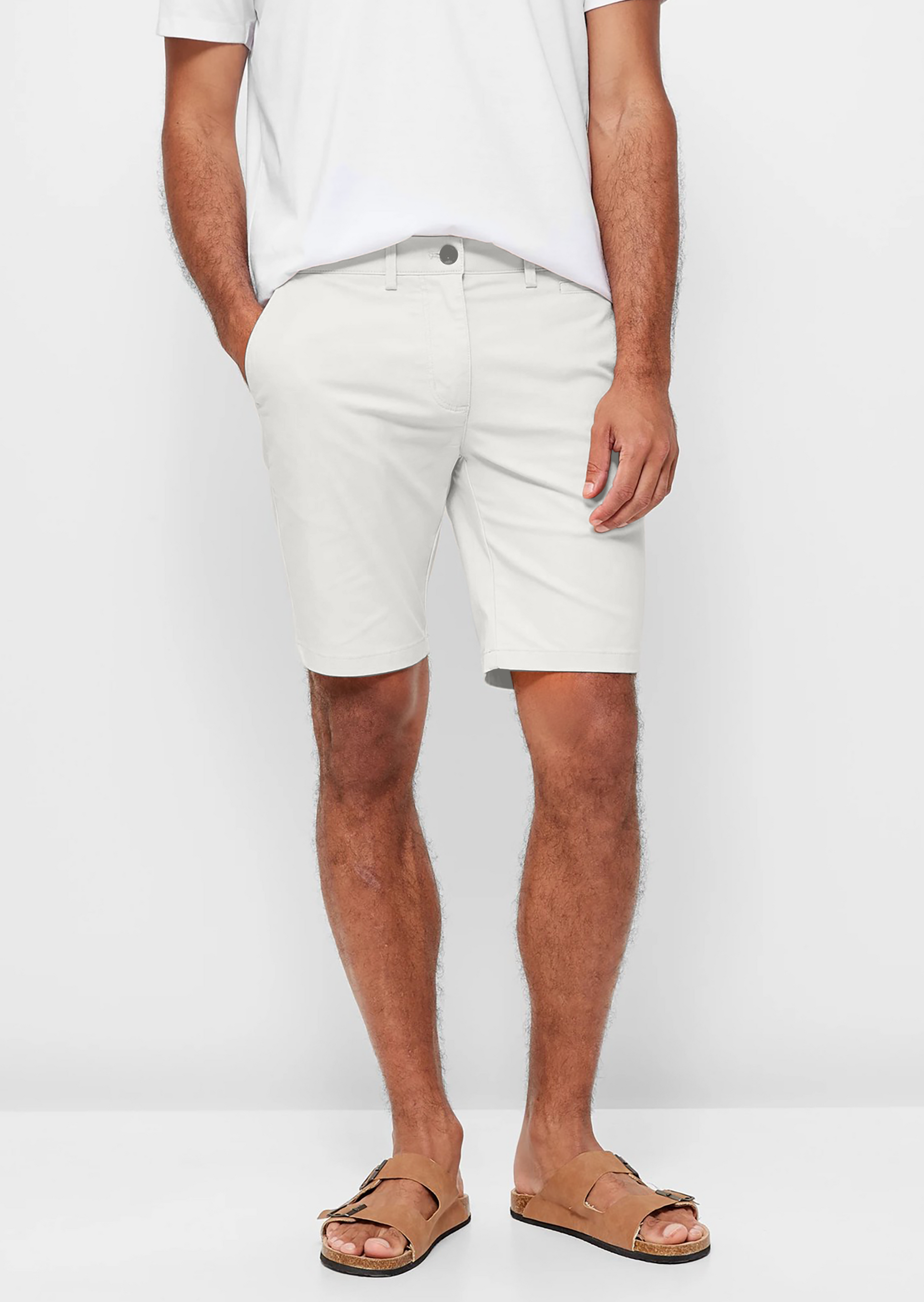 Mens White chinos shorts with front slanted pockets, jetted back pockets. zip fly fastening and brown horne buttons on the waistband and back pockets, the fit is a slim fit, this is worn with a white tee and white t-shirt