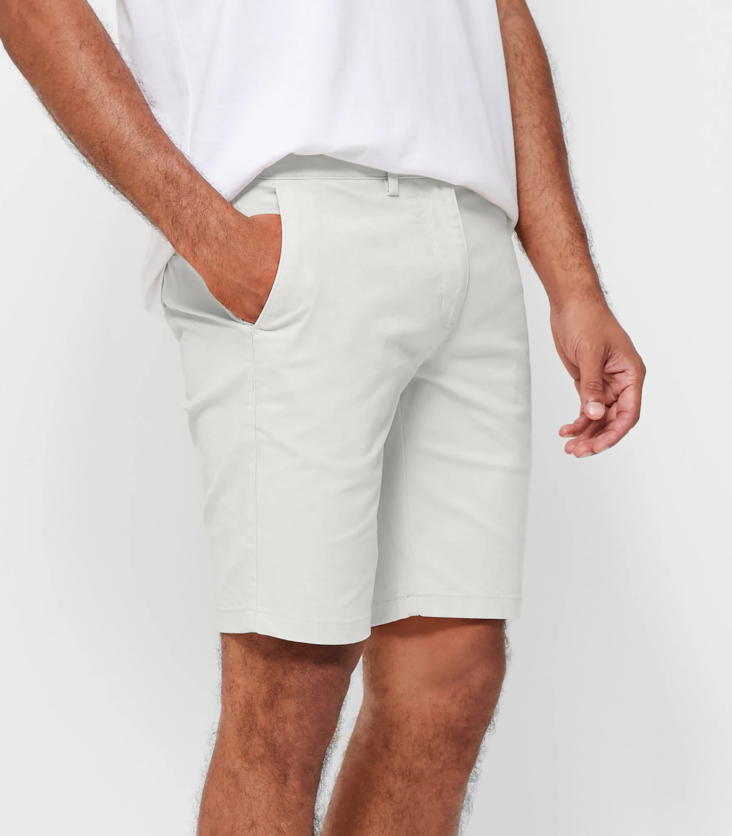 Mens White chinos shorts with front slanted pockets, jetted back pockets. zip fly fastening and brown horne buttons on the waistband and back pockets, the fit is a slim fit, this is worn with a white tee and white t-shirt