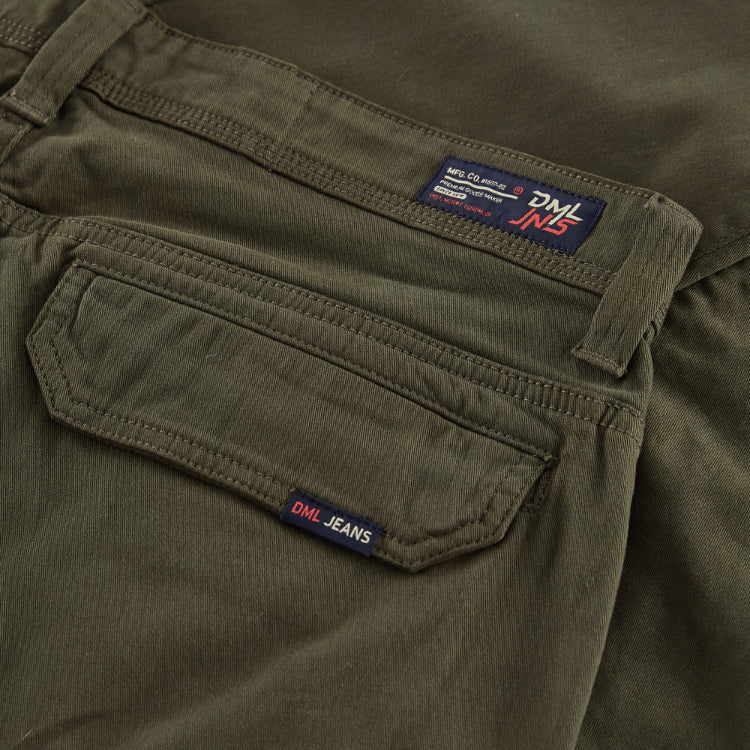 Close-up of green pants with a visible brand label.