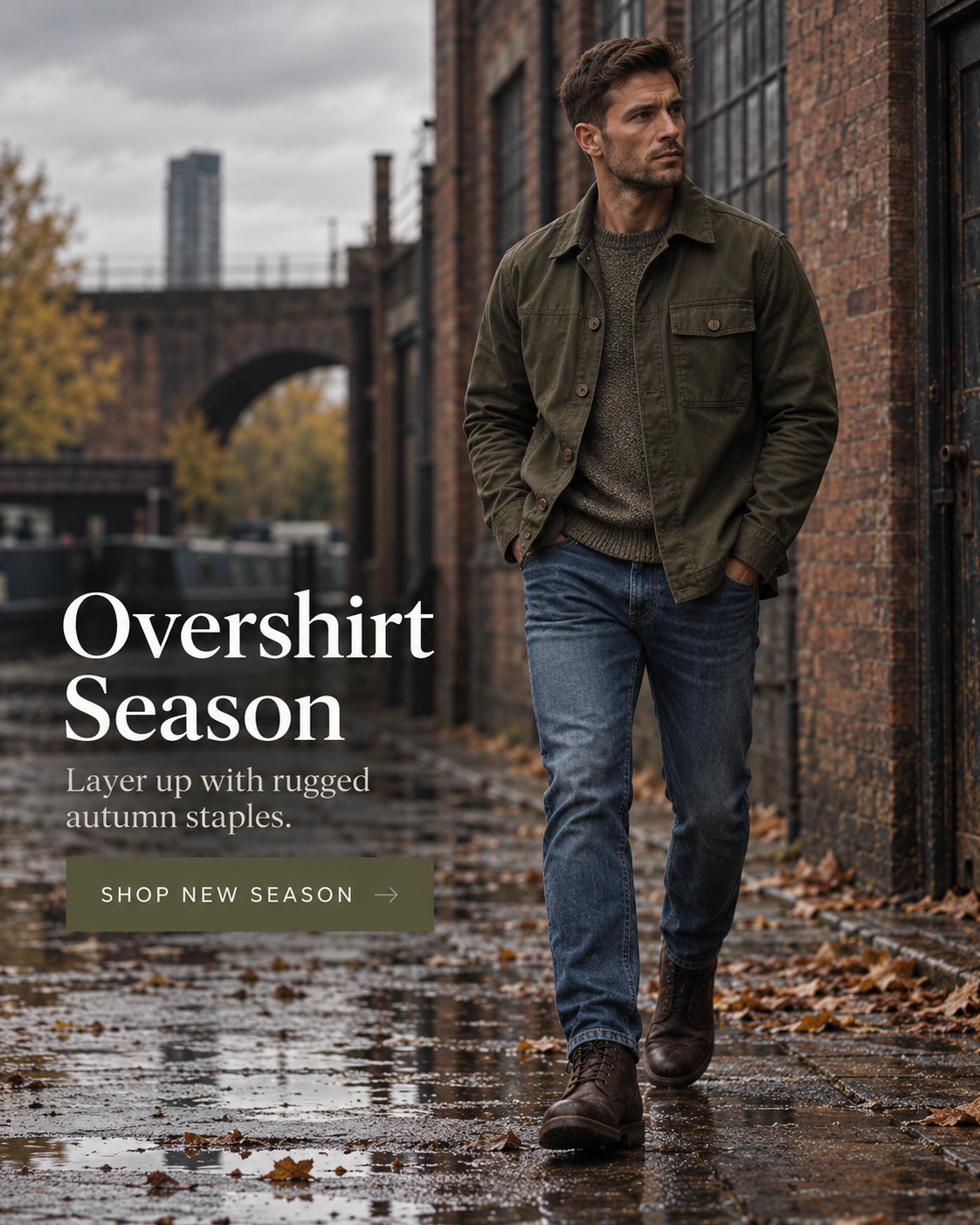 A man walks down a wet brick alleyway in an urban setting, wearing a dark olive green overshirt over a light gray sweater and blue jeans. Large text on the left reads 'Overshirt Season' with a 'SHOP NEW SEASON' button below it.
