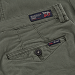 close up image of back pocket on a mens slim fit chino trouser in dark olive from the DML Jeans brand