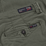 close up image of back pocket on a mens slim fit chino trouser in dark olive from the DML Jeans brand